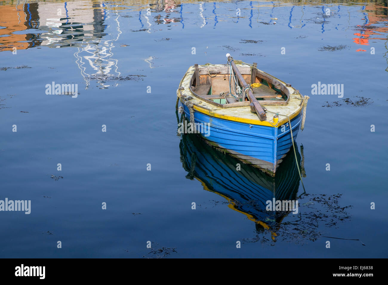 Old wooden dinghy moored in Falmouth harbour Cornwall England UK Stock Photo