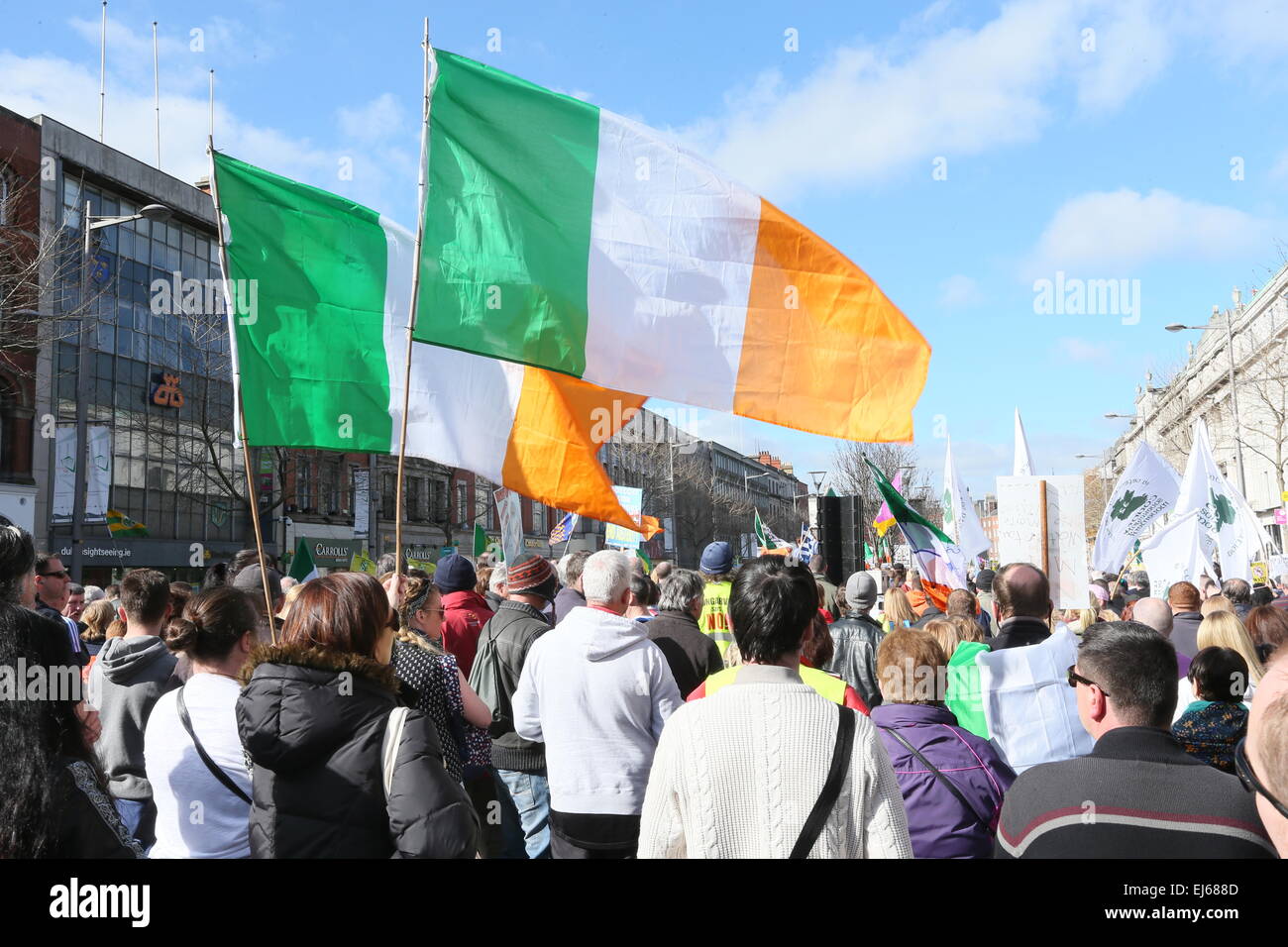 Irish tricolours fly at the anti-water charges Right2Water protest in Dublin city centre. Stock Photo