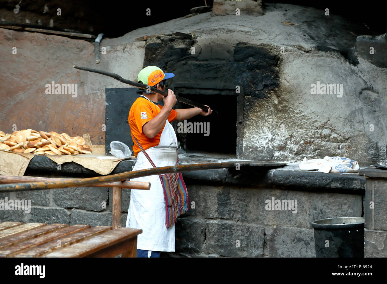 Baker making empanadas, historic Horno Colonial San Francisco (San Francisco Colonial Oven), Pisac, Cusco, Peru Stock Photo