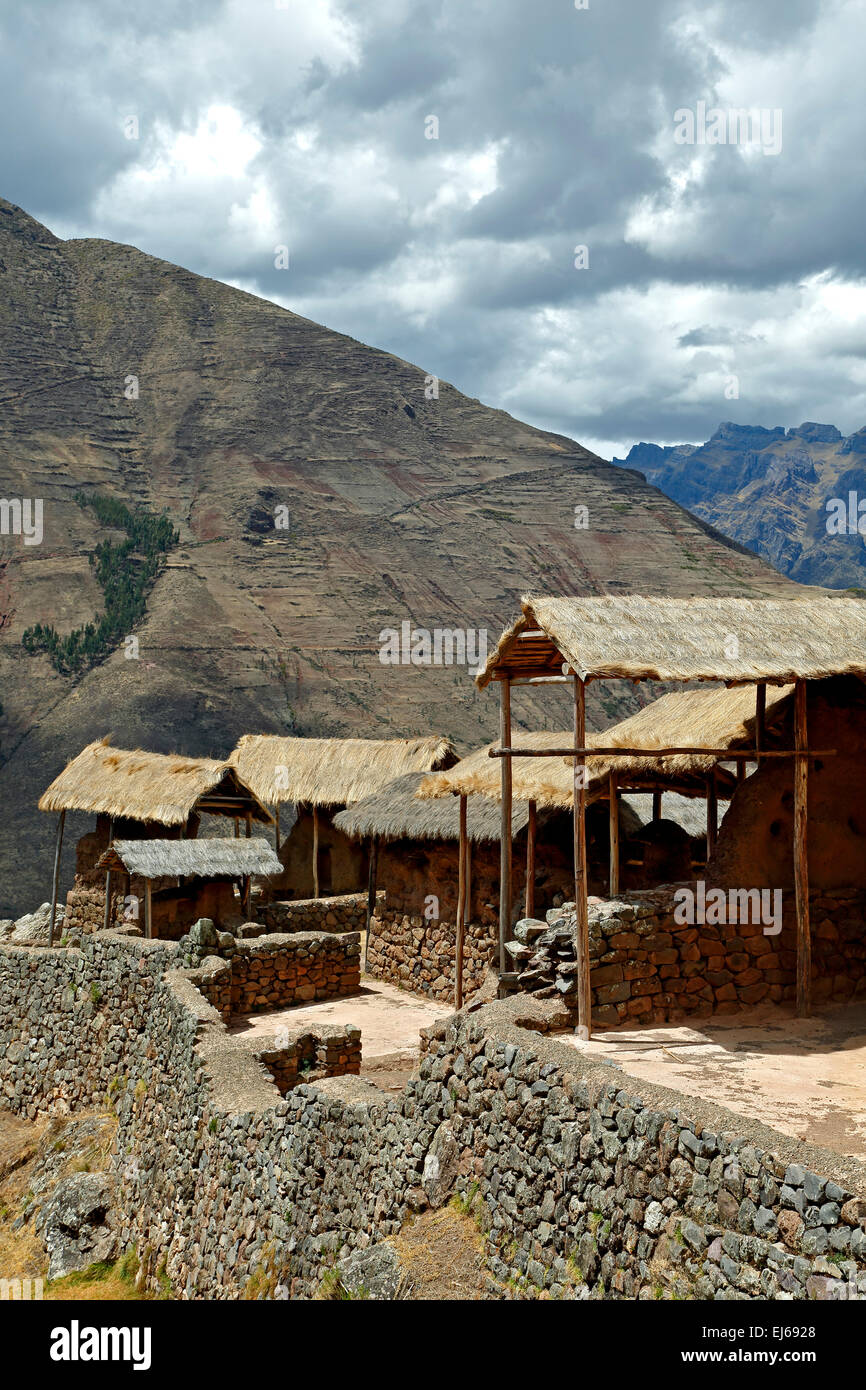 Thatch roof-covered buildings, Pisac Inca ruins, Pisac, Cusco, Peru Stock Photo