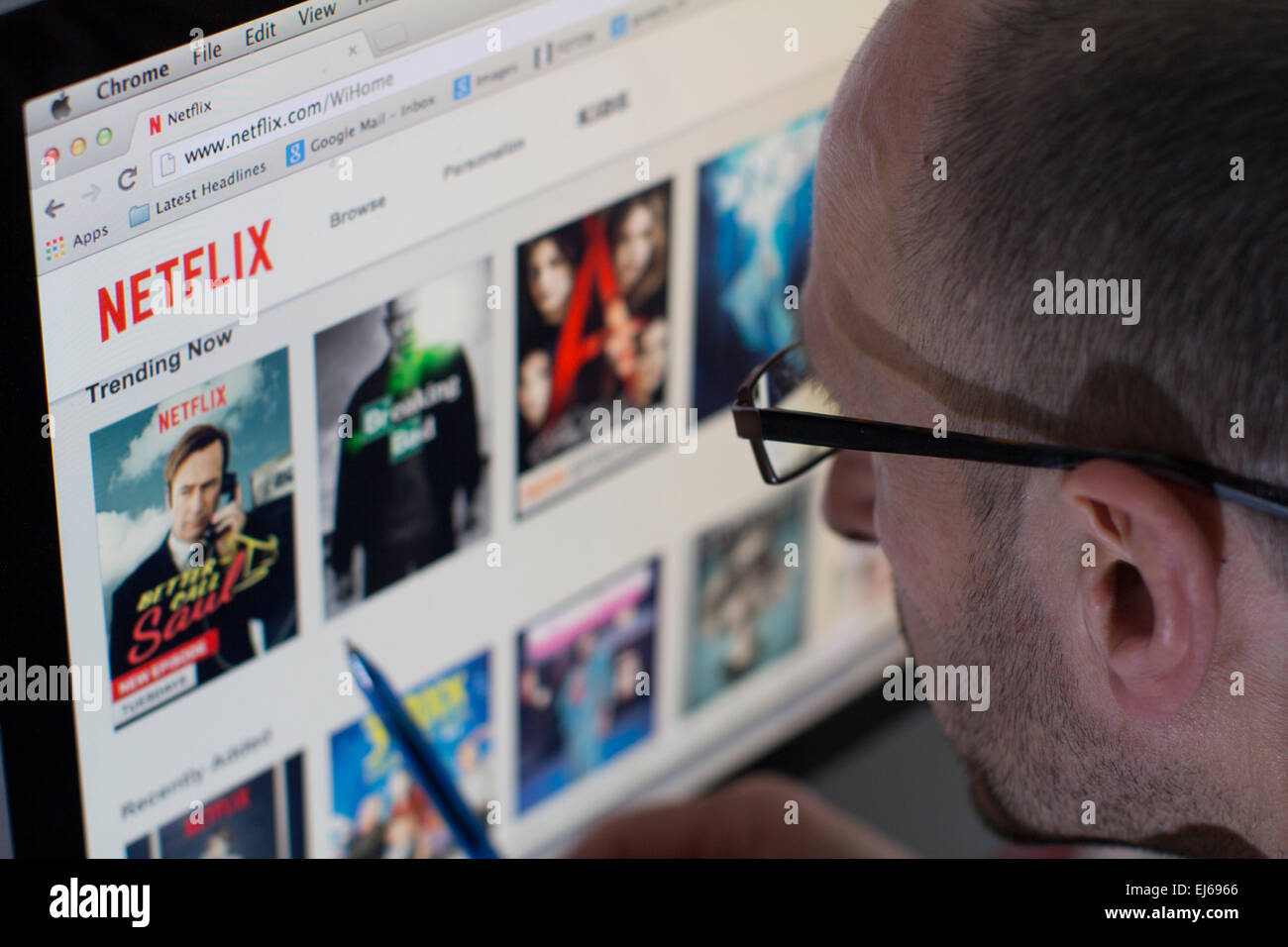 Male looking at the website of Netflix Television streaming service Stock Photo