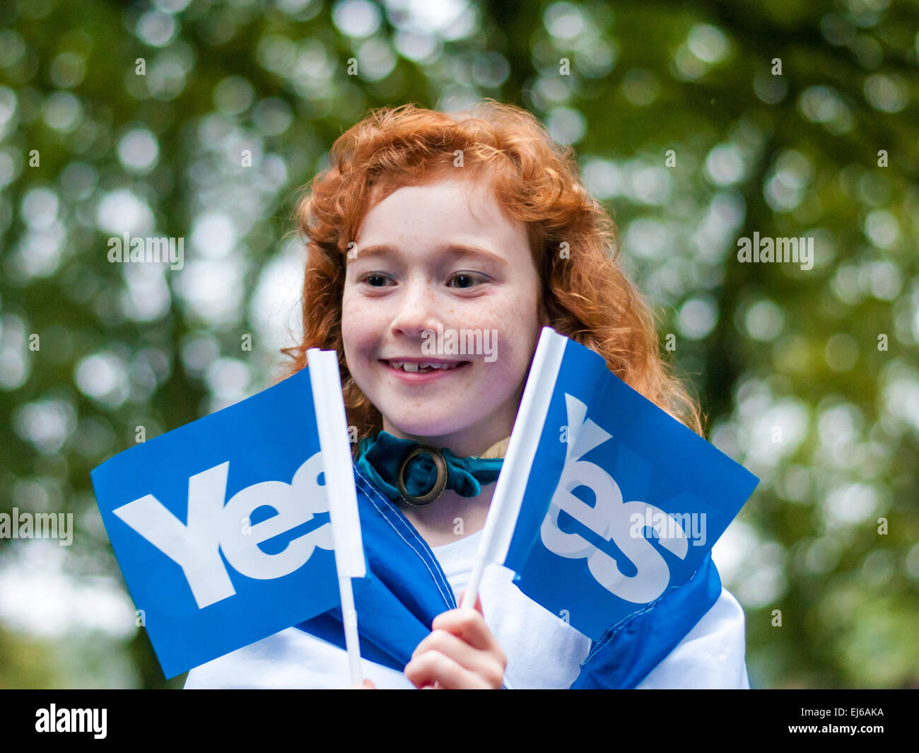 A little girl with red hair holds to Vote Yes flags at a pro-independence Vote Yes rally in Edinburgh's Meadows. Where: Edinburgh, Scotland, United Kingdom When: 17 Sep 2014 Stock Photo