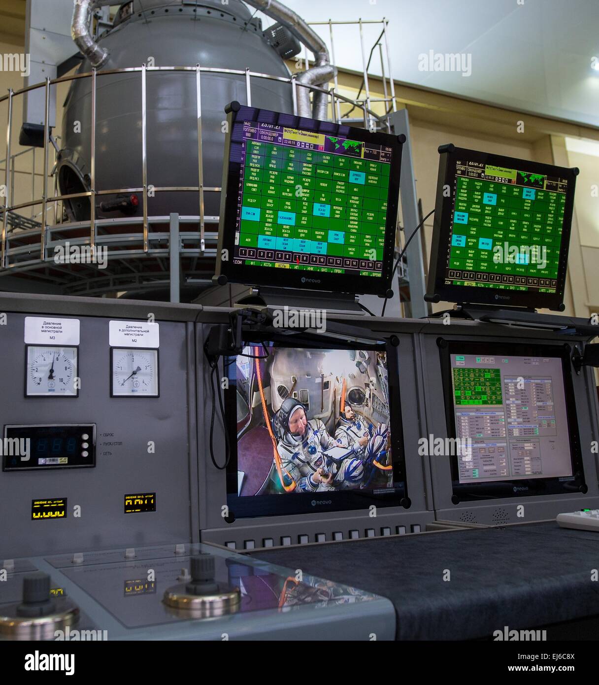 International Space Station Expedition 43 Cosmonauts Gennady Padalka and Mikhail Kornienko of the Russian Federal Space Agency sit inside the Soyuz simulator as seen from the control room monitors at the Gagarin Cosmonaut Training Center March 8, 2015 in Star City, Russia. Gennady Padalka and Mikhail Kornienk and Scott Kelly will launch aboard the Soyuz spacecraft March 28th for a one-year mission. Stock Photo