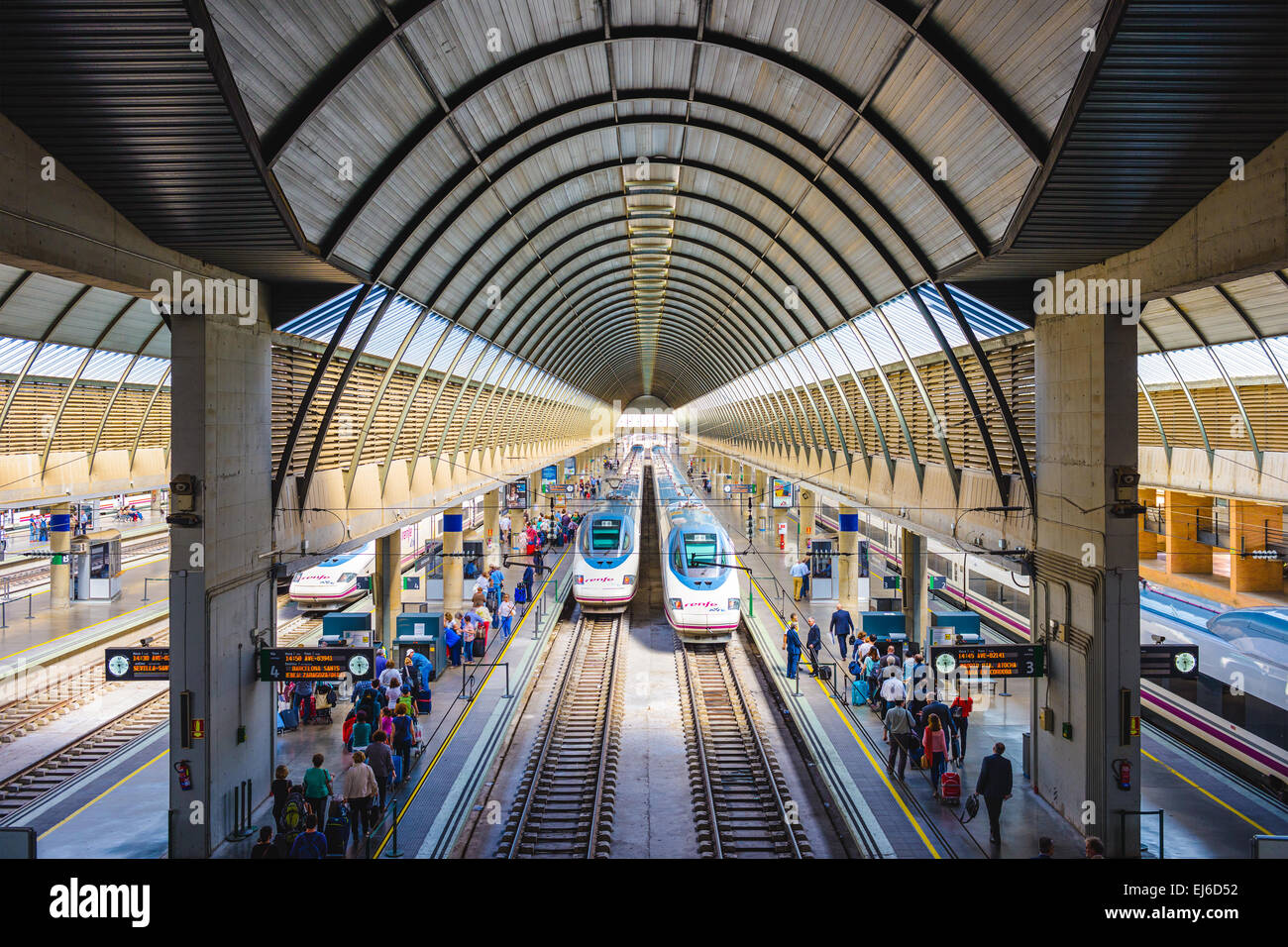 Passengers and trains at Santa Justa Station in Seville, Spain. Stock Photo