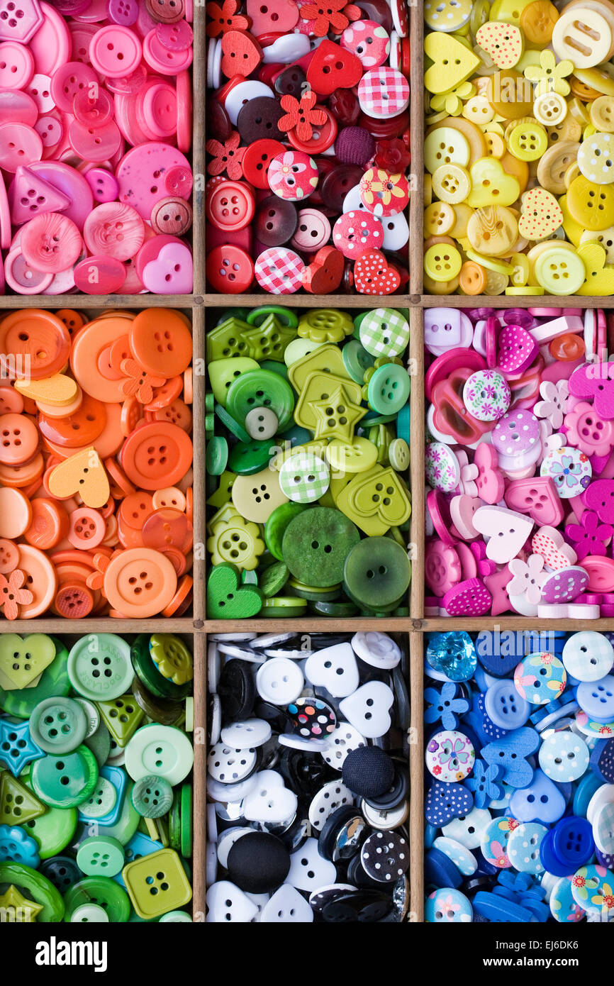 Colourful buttons in a wooden draw. Stock Photo
