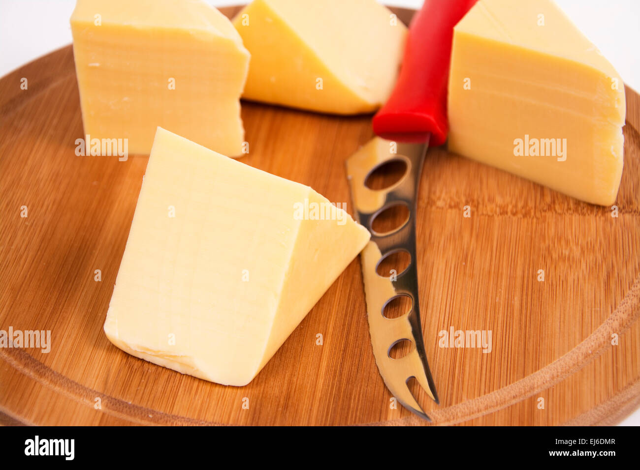 Sliced cheese on the board in the kitchen Stock Photo