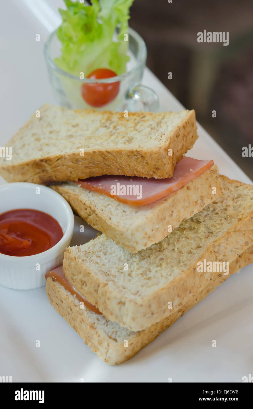 close up toasted sandwich with ham and cheese on dish Stock Photo