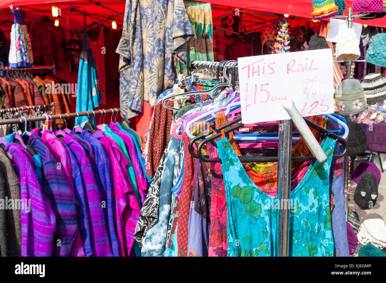 Dress rail with dresses for sale with a price ticket showing cheap prices for clothes on a clothing stall at a market, Nottingham, England, UK Stock Photo
