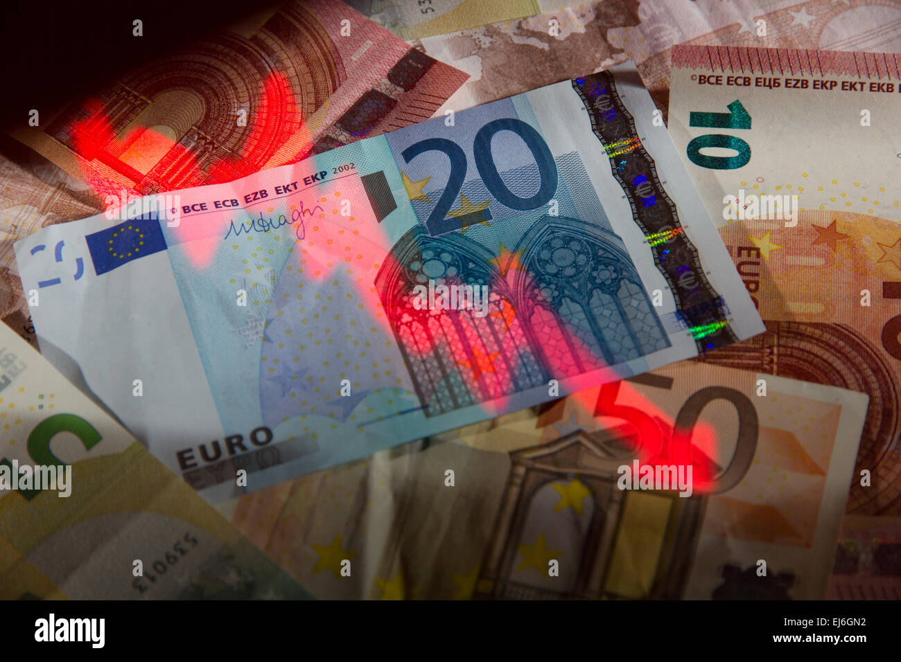 Down trending 'stock market graph' projected onto a pile of Euros Stock Photo