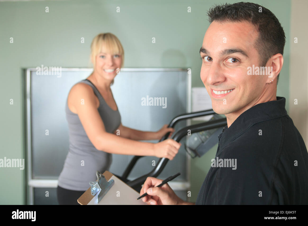 gym woman personal trainer man with weight training Stock Photo Alamy