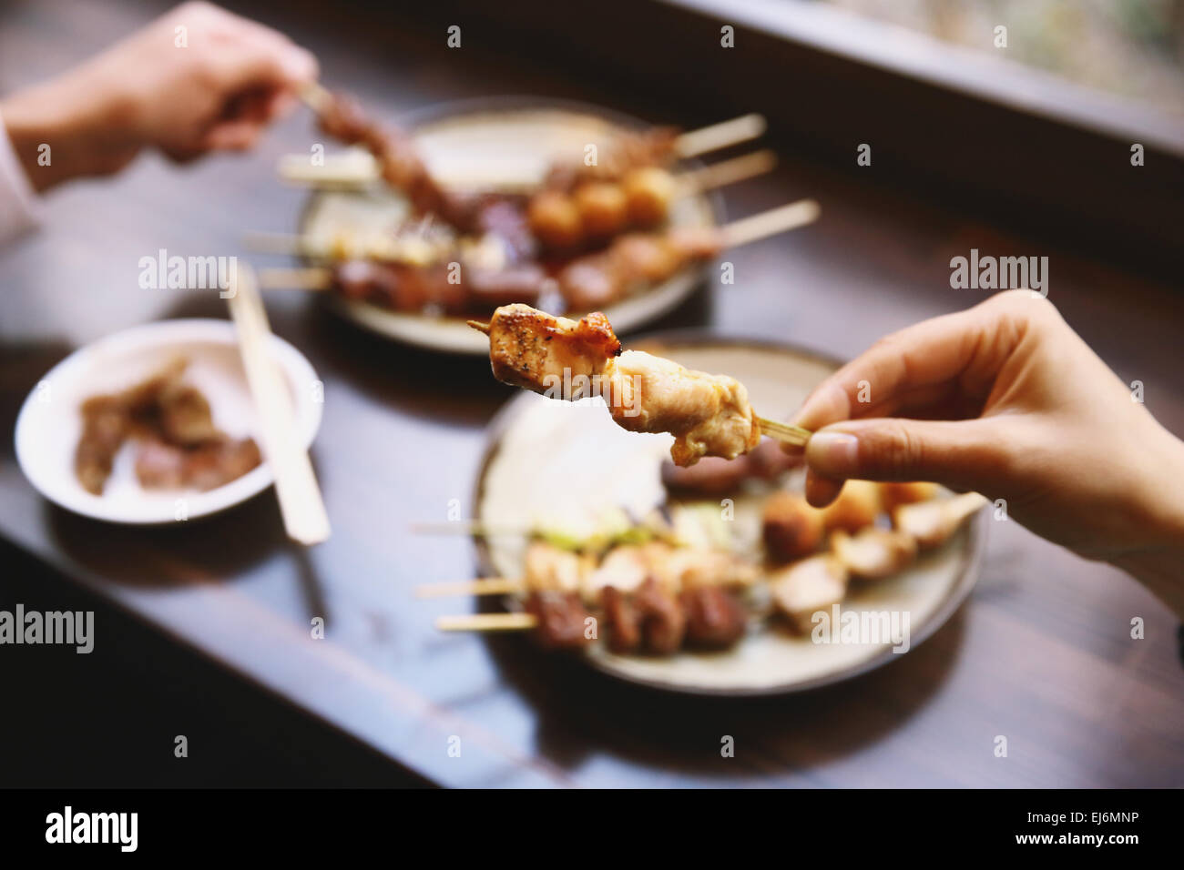 People eating Japanese style Yakitori Stock Photo Alamy