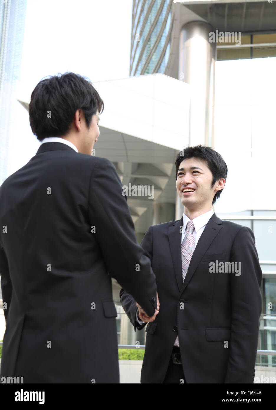 Japanese businessmen shaking hands Stock Photo