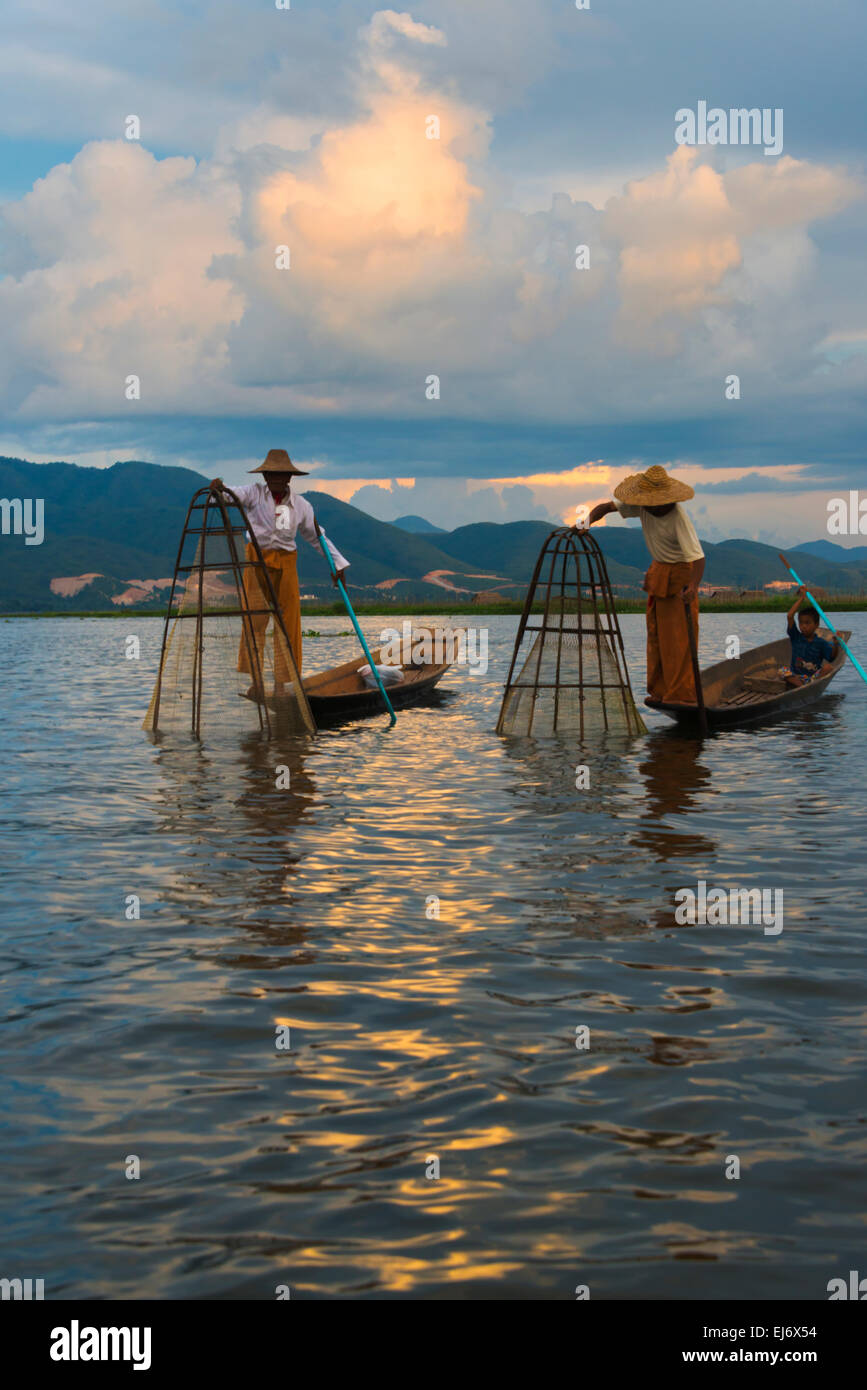 Intha fisherman rowing boat with leg at sunset on Inle Lake, Shan State, Myanmar Stock Photo