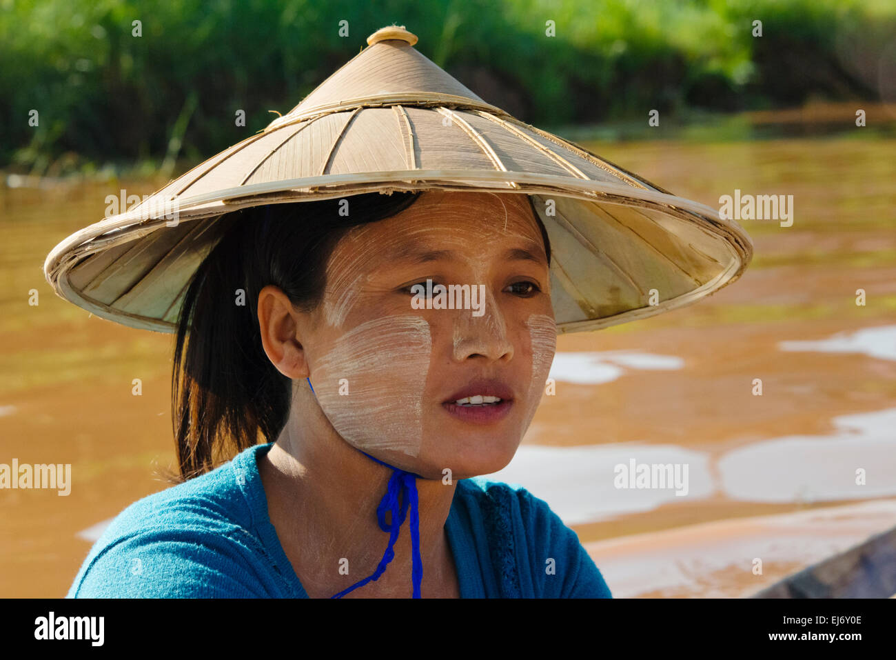 Portrait of a girl wearing conical hat with face painted white by sunblock, Inle Lake, Shan State, Myanmar Stock Photo