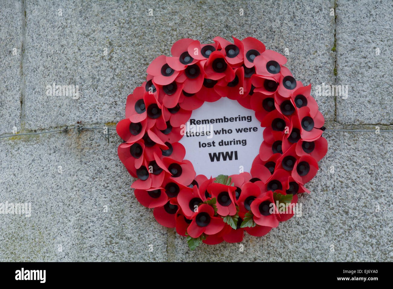 Poppy ring on remembrance for troops killed during World War One at war memorial in Launceston, Cornwall, England Stock Photo
