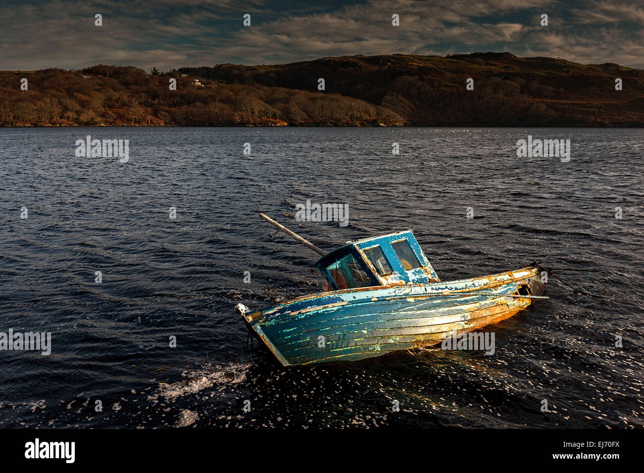 Partially submerged old wooden boat in bay, near Killybegs, County Donegal, Republic of Ireland, Europe. Stock Photo
