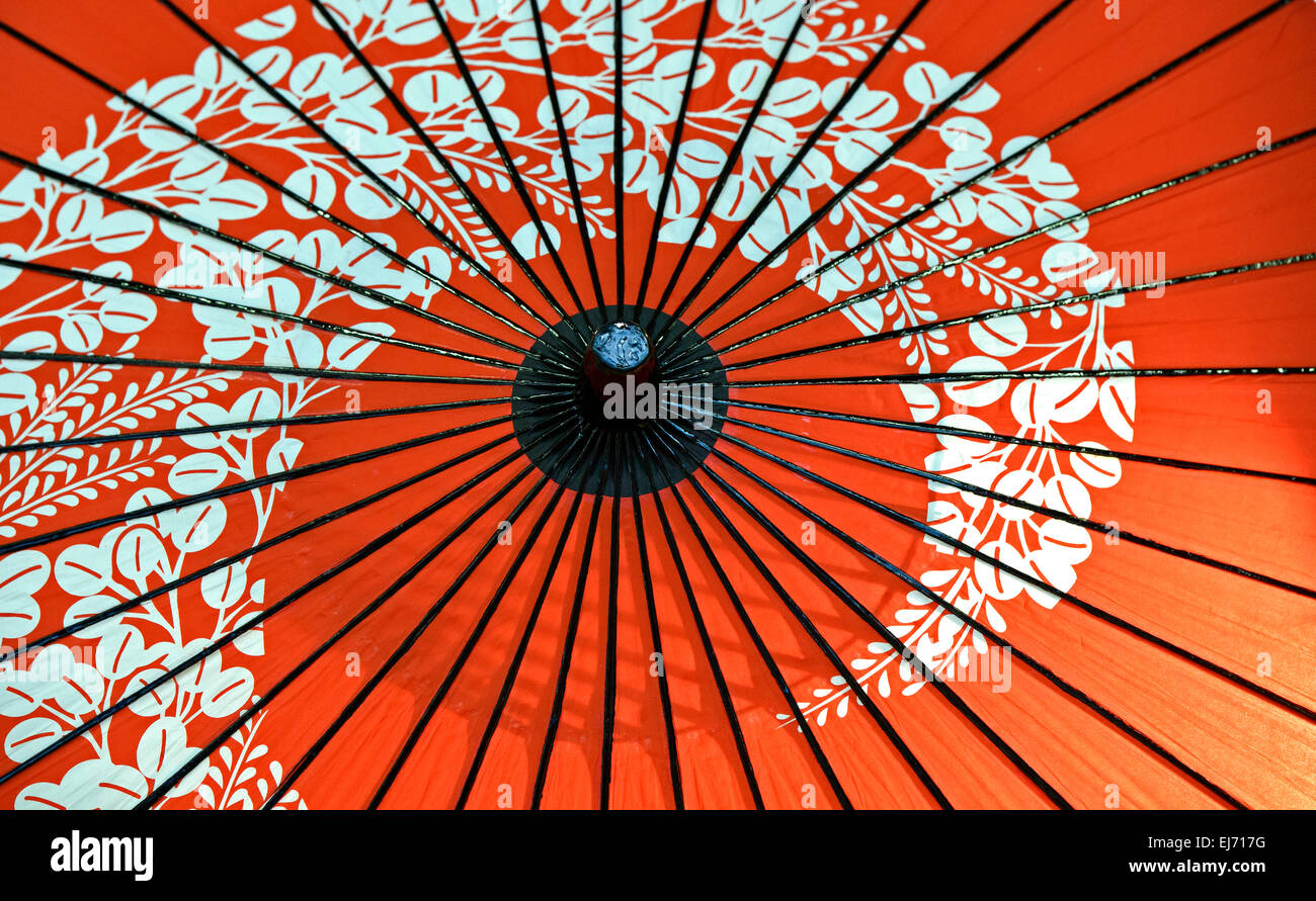 Traditional Japanesestyle red oilpaper umbrella with a cherry blossom