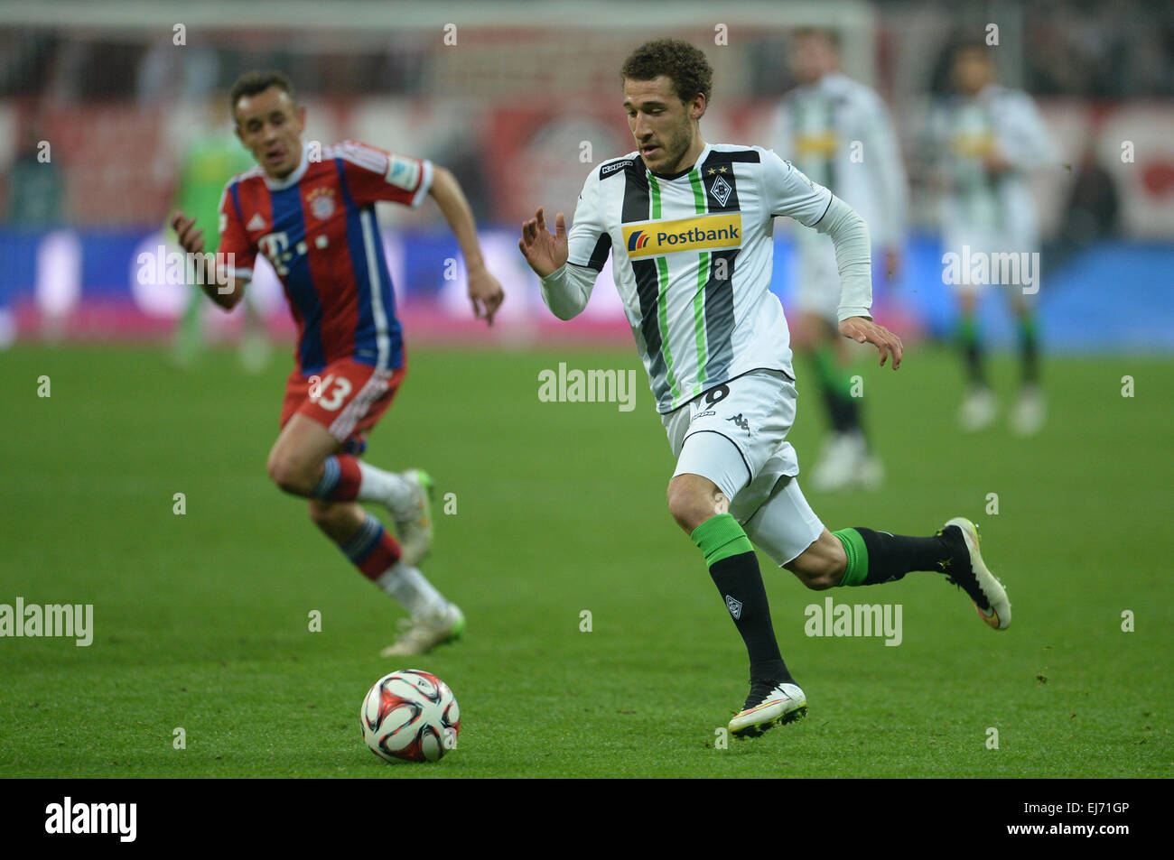 Munich, Germany. 22nd Mar, 2015. Munich's Rafinha (L) vies for the ball with Gladbach's Fabian Johnson during the German Bundesliga soccer match between FC Bayern Munich and Borussia Moenchengladbach in the Allianz Arena in Munich, Germany, 22 March 2015. Photo: ANDREAS GEBERT/dpa/Alamy Live News Stock Photo