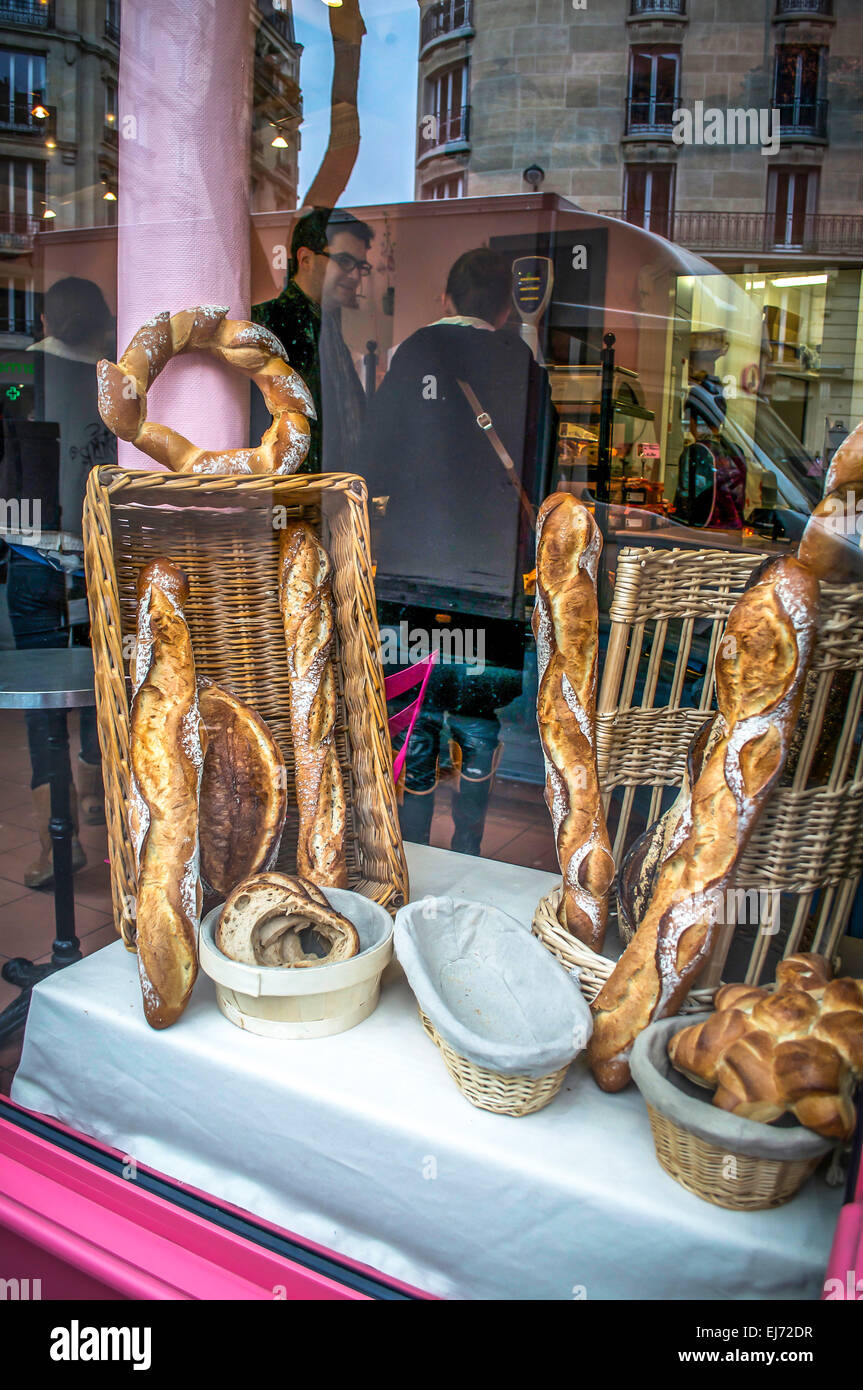 Boulangerie window displaying a variety of bread loaves or buns for sale in Paris, France. Stock Photo