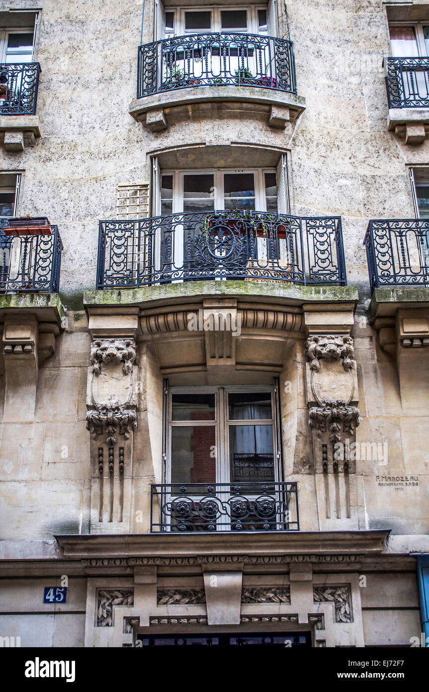 An elegant 1913 building with sculptured elements & lacy iron balconies on Rue Lamarck in Paris, France. Designed by P. Marozea. Stock Photo