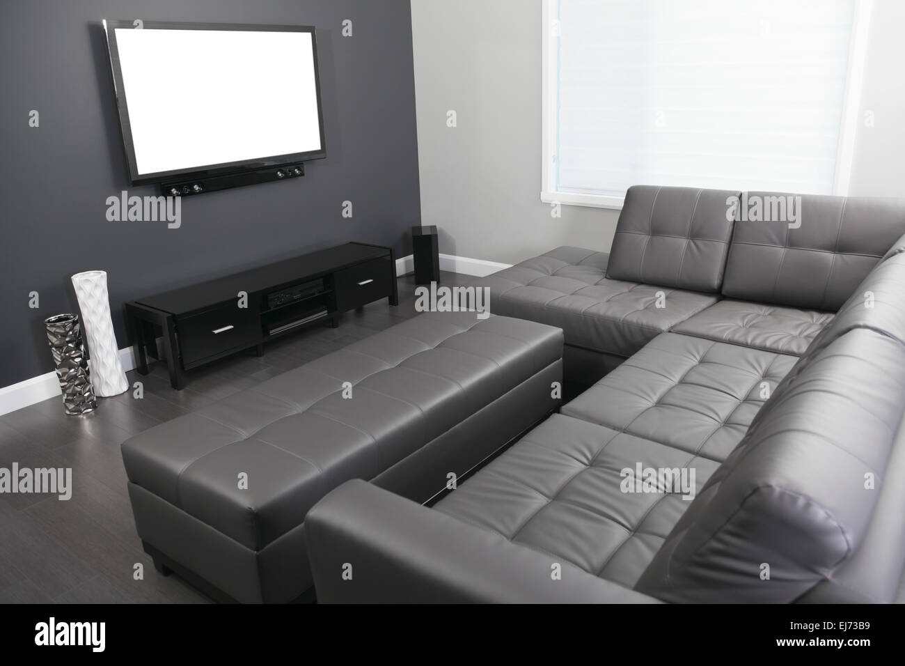 gray and white living room with tv stand and sofa Stock Photo - Alamy