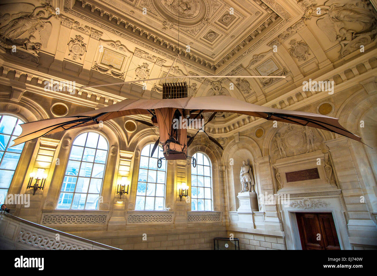 Early airplane, 1893-1897, by Clement Ader hangs from ornate ceiling of the grand staircase in Musee des Arts et Metiers, Paris. Stock Photo