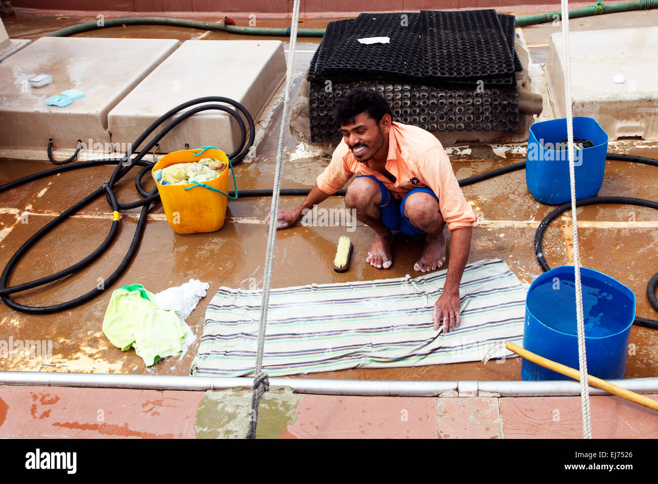 An Abu Dhabi fisherman does the laundry aboard his dhow. Stock Photo