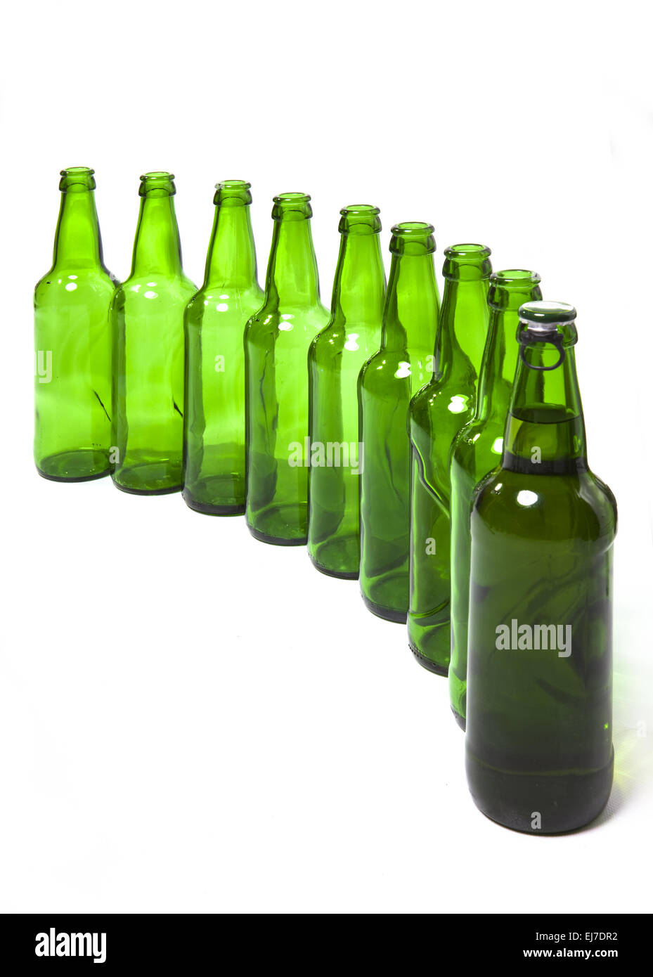 Empty glass bottles and one full Stock Photo Alamy