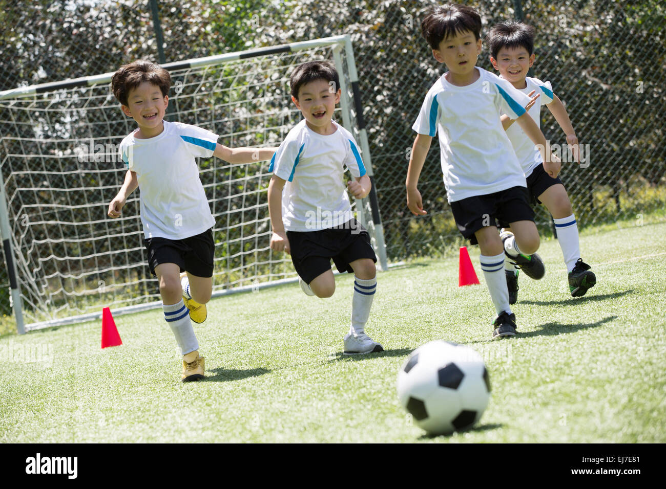 The boys playing football on the playground Stock Photo Alamy