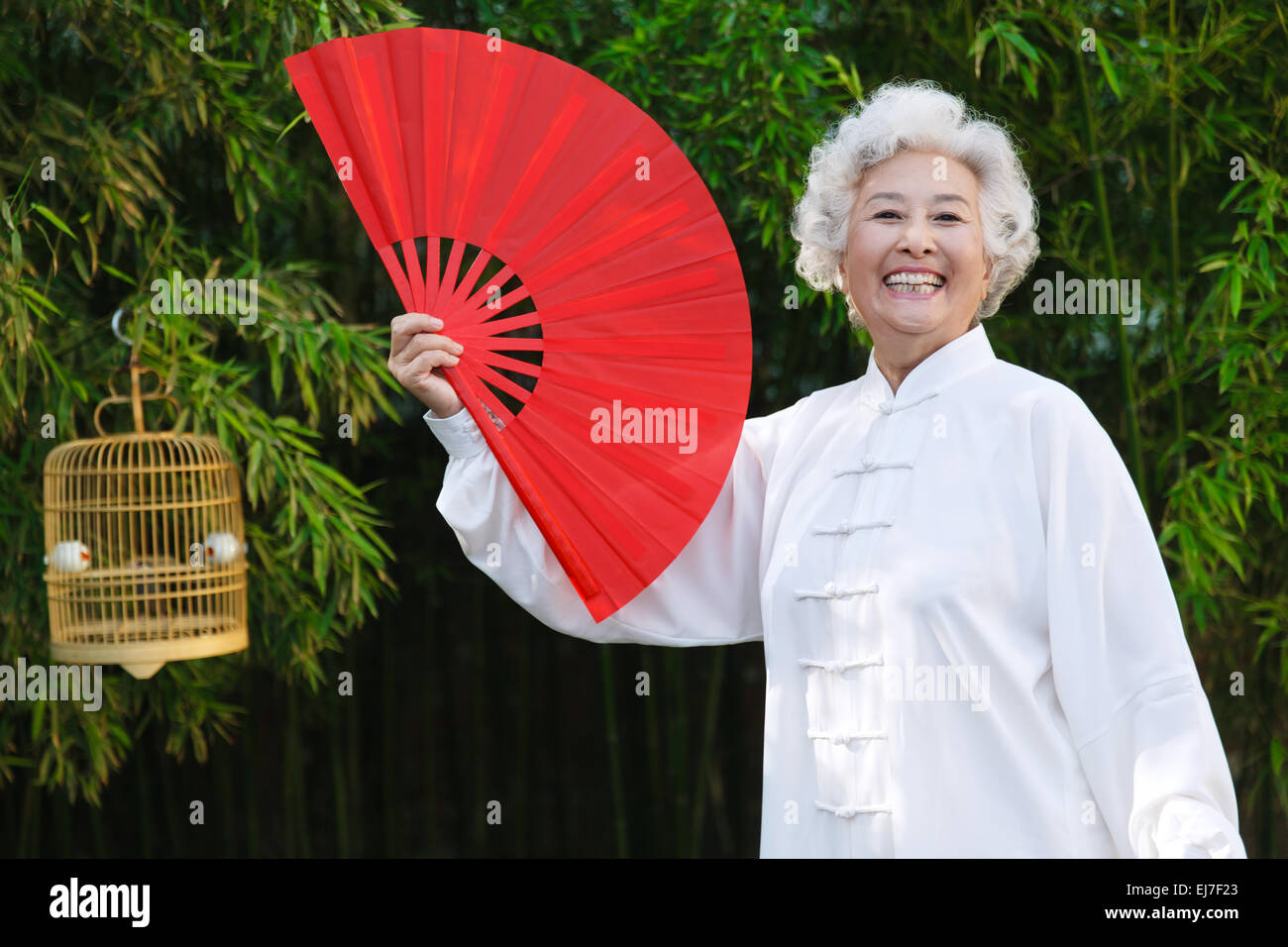 An woman with fan in the morning exercise Stock Photo - Alamy