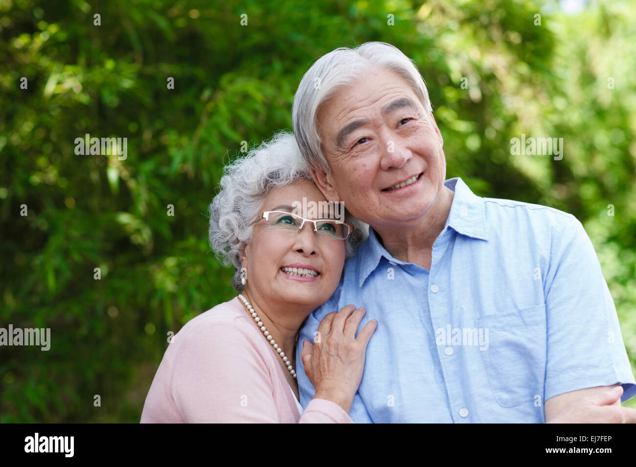 The old couple embracing in the outdoor courtyard Stock Photo