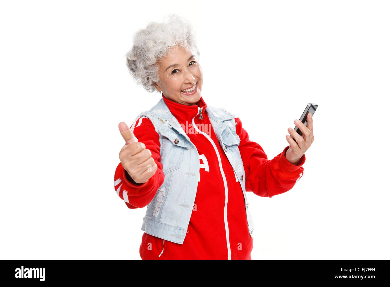 The old man holding a cell phone and a thumbs up Stock Photo