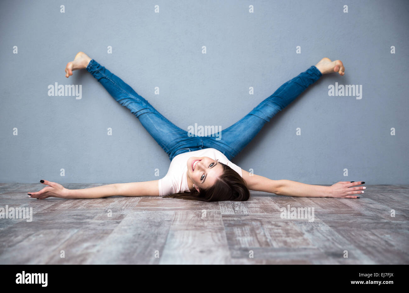 A Young Woman Lying on the Floor in the Studio Showing Her Big Long Legs and Bottom, on a White Background. Copy Space Stock Photo - Image of legs, fitness: 181216346