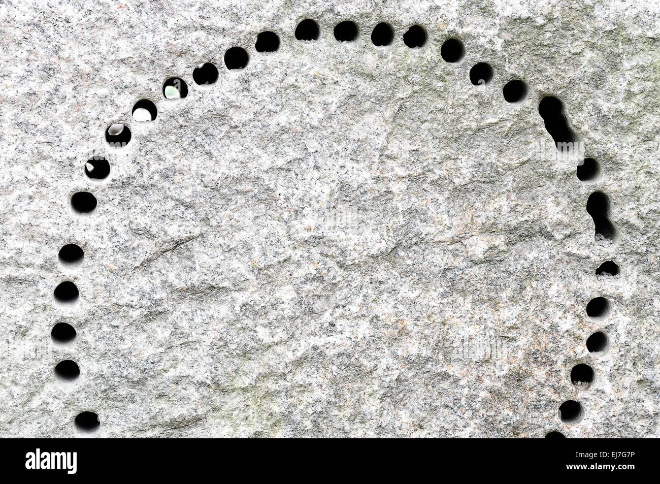many holes in granite stone Stock Photo Alamy
