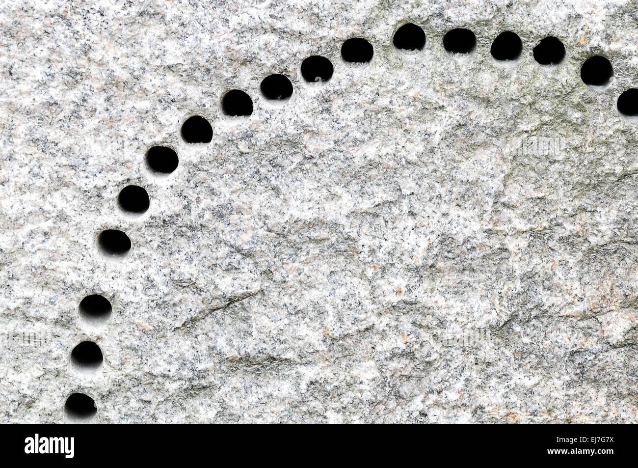 drilled many holes in the granite Stock Photo