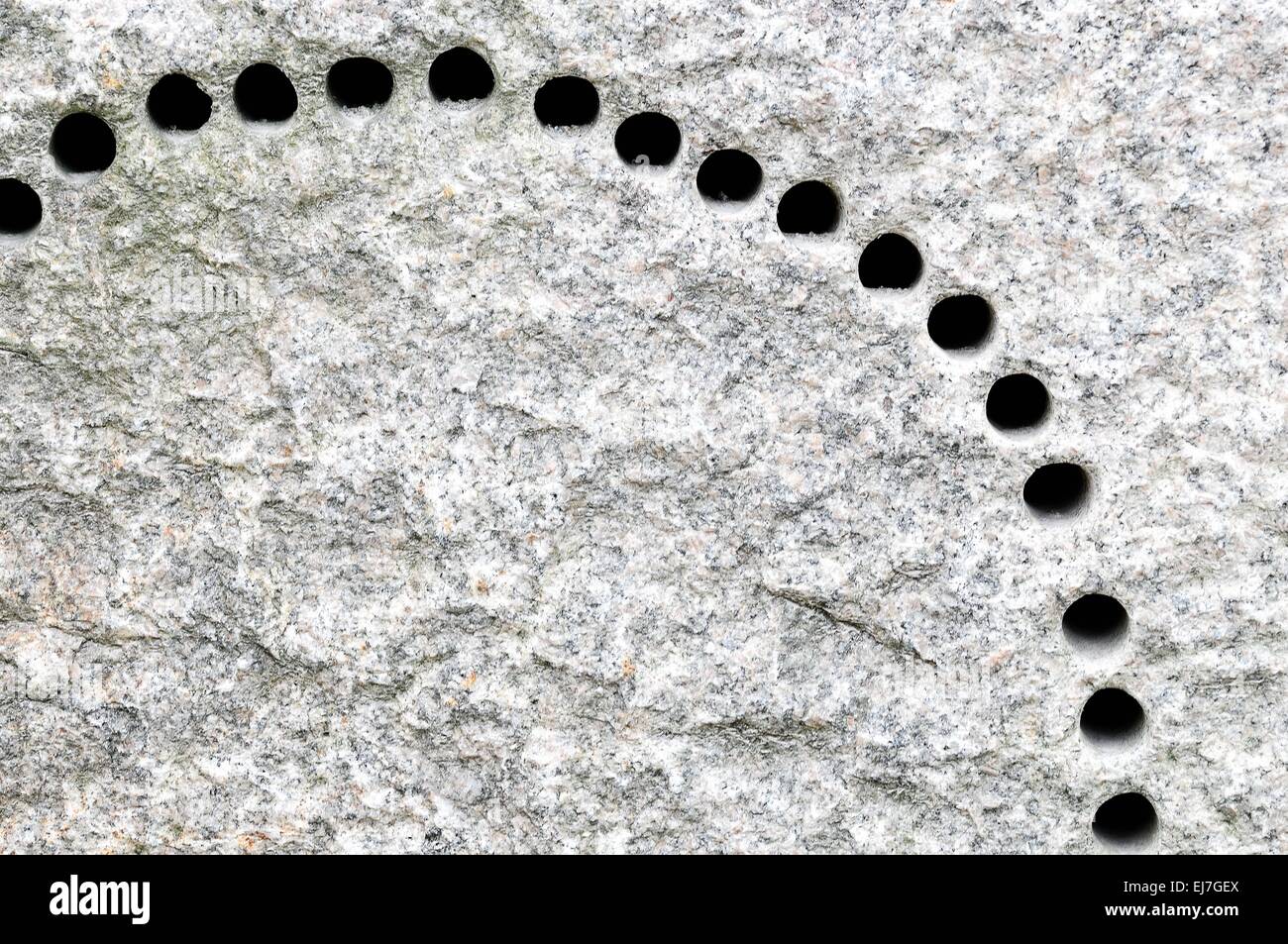 Drill holes in granite stone Stock Photo