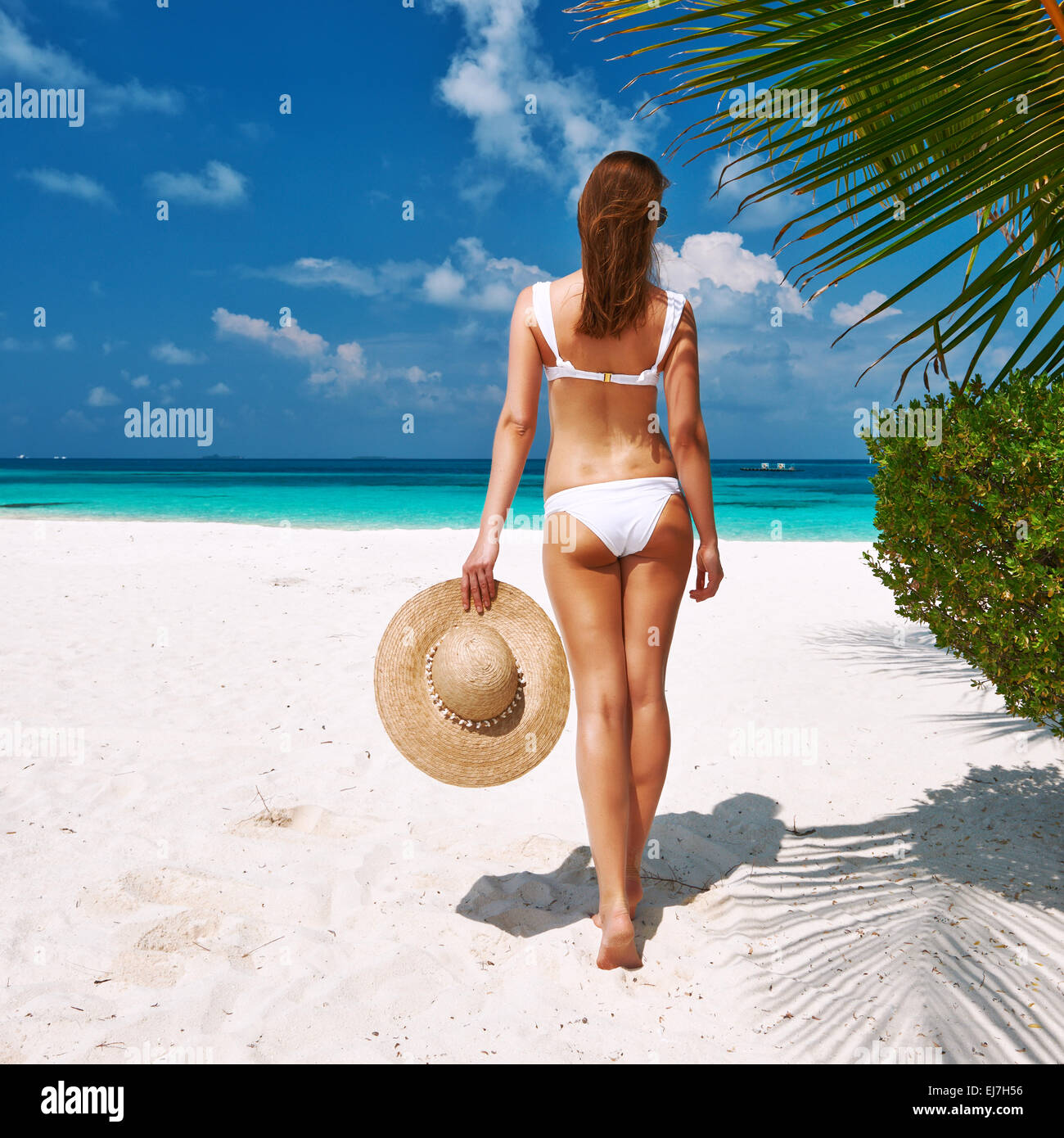 Woman in bikini on a beach at Maldives Stock Photo - Alamy
