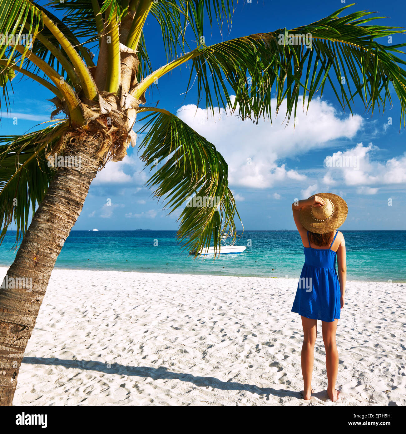 Woman in blue dress on a beach at Maldives Stock Photo - Alamy
