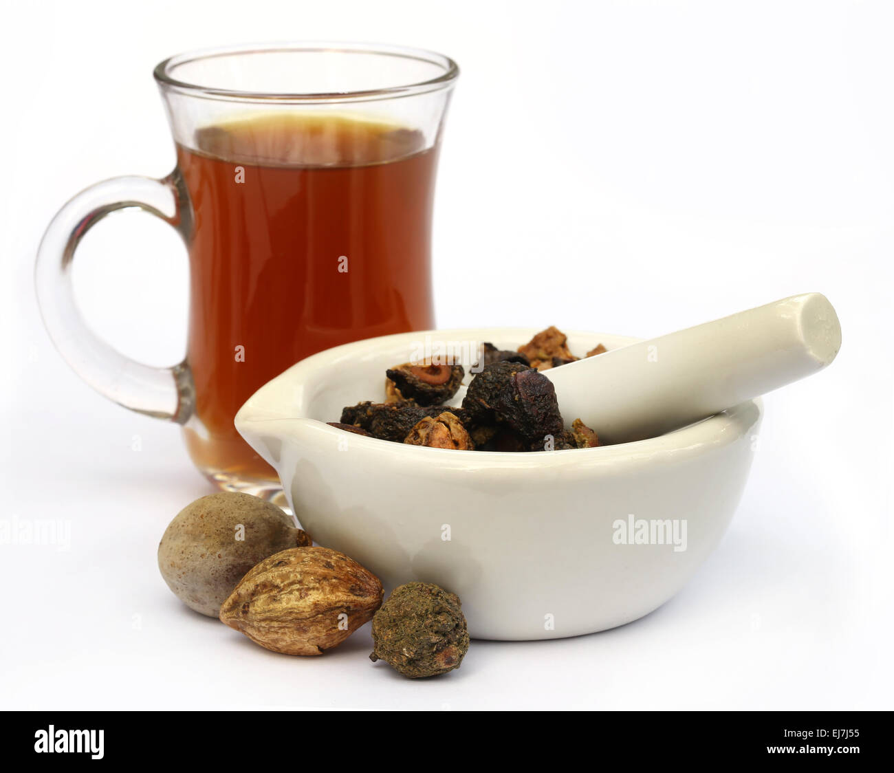 Tea made from Triphala, a combination of ayurvedic fruits with mortar and pestle Stock Photo