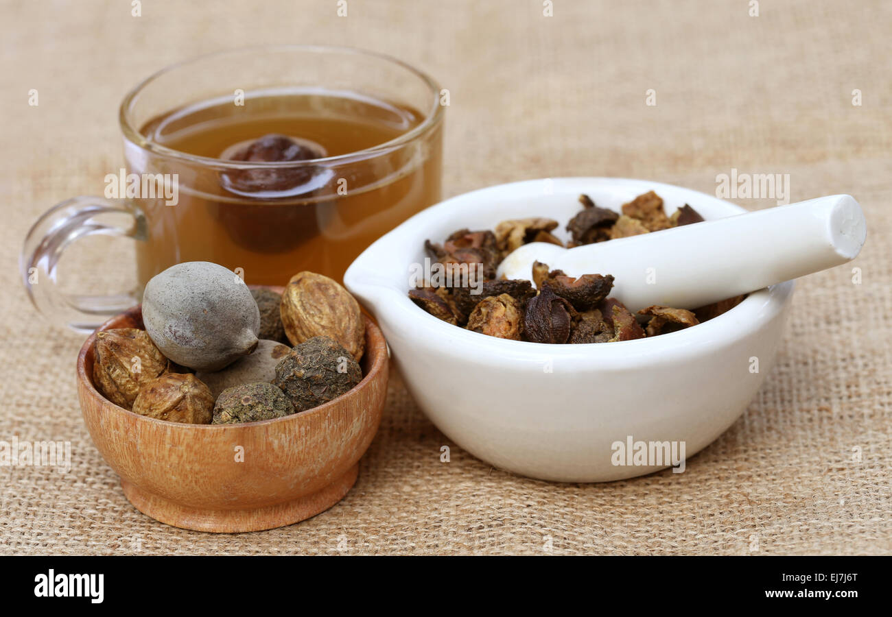 Tea made from Triphala, a combination of ayurvedic fruits with mortar and pestle Stock Photo
