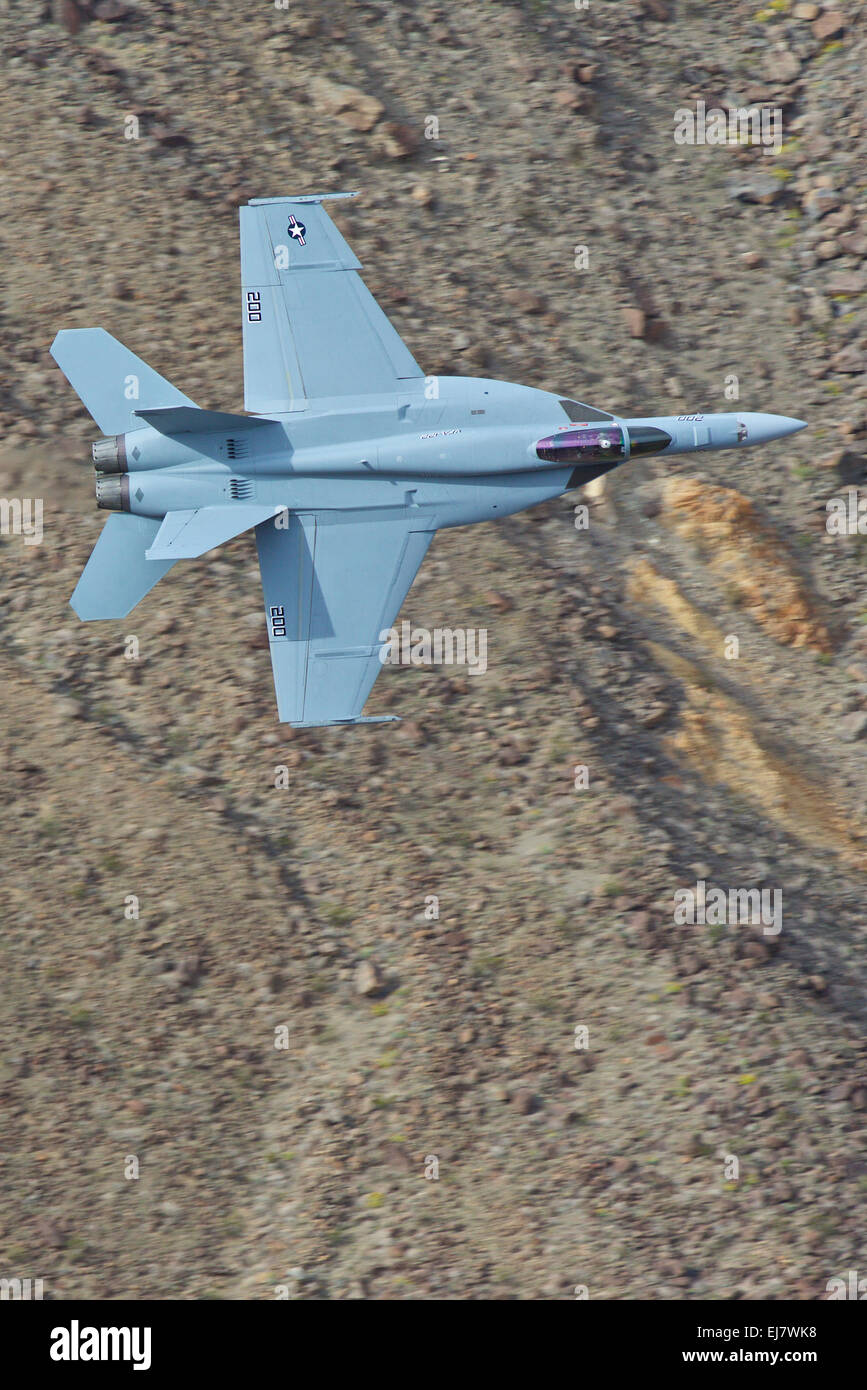 Close Up Of A US Navy F/A-18E Super Hornet Jet Fighter Banking Steeply In A Desert Canyon. Stock Photo