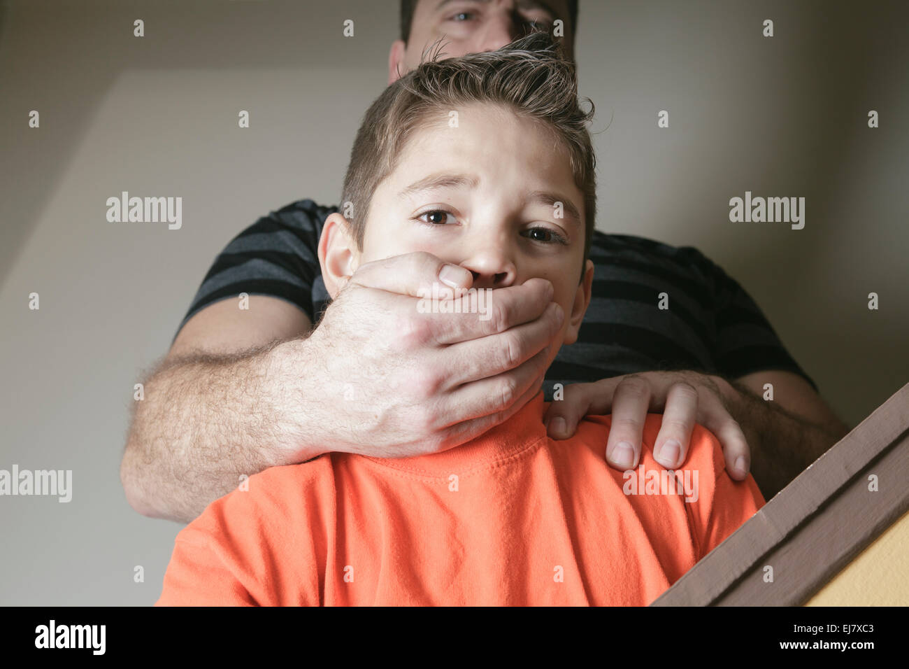 father abused his young boy at home Stock Photo