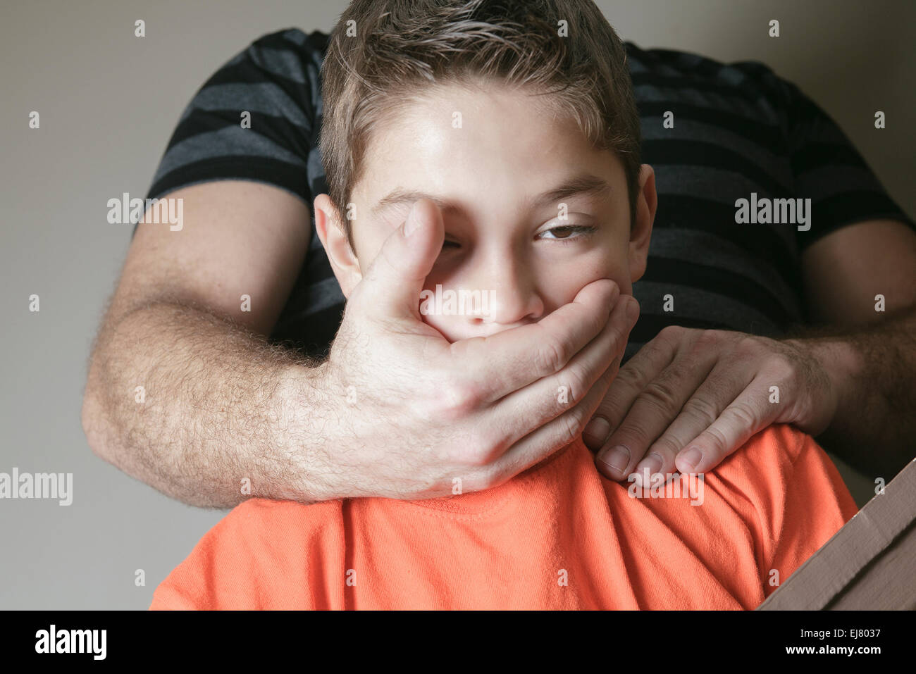 father abused his young boy at home Stock Photo