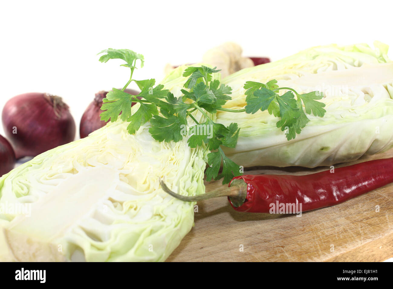 pointed cabbage with hot peppers on a board Stock Photo
