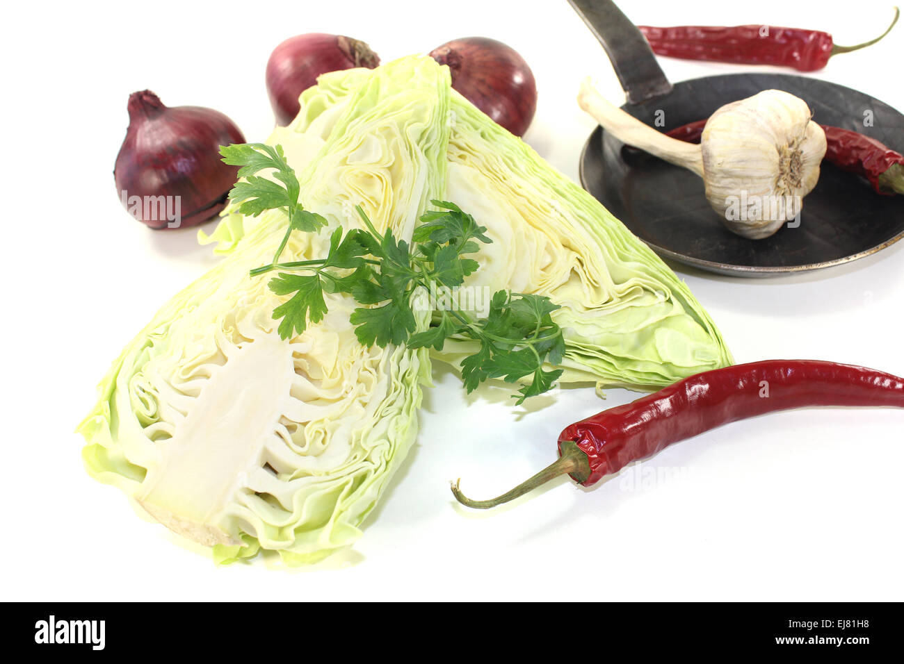pointed cabbage with onions in a pan Stock Photo