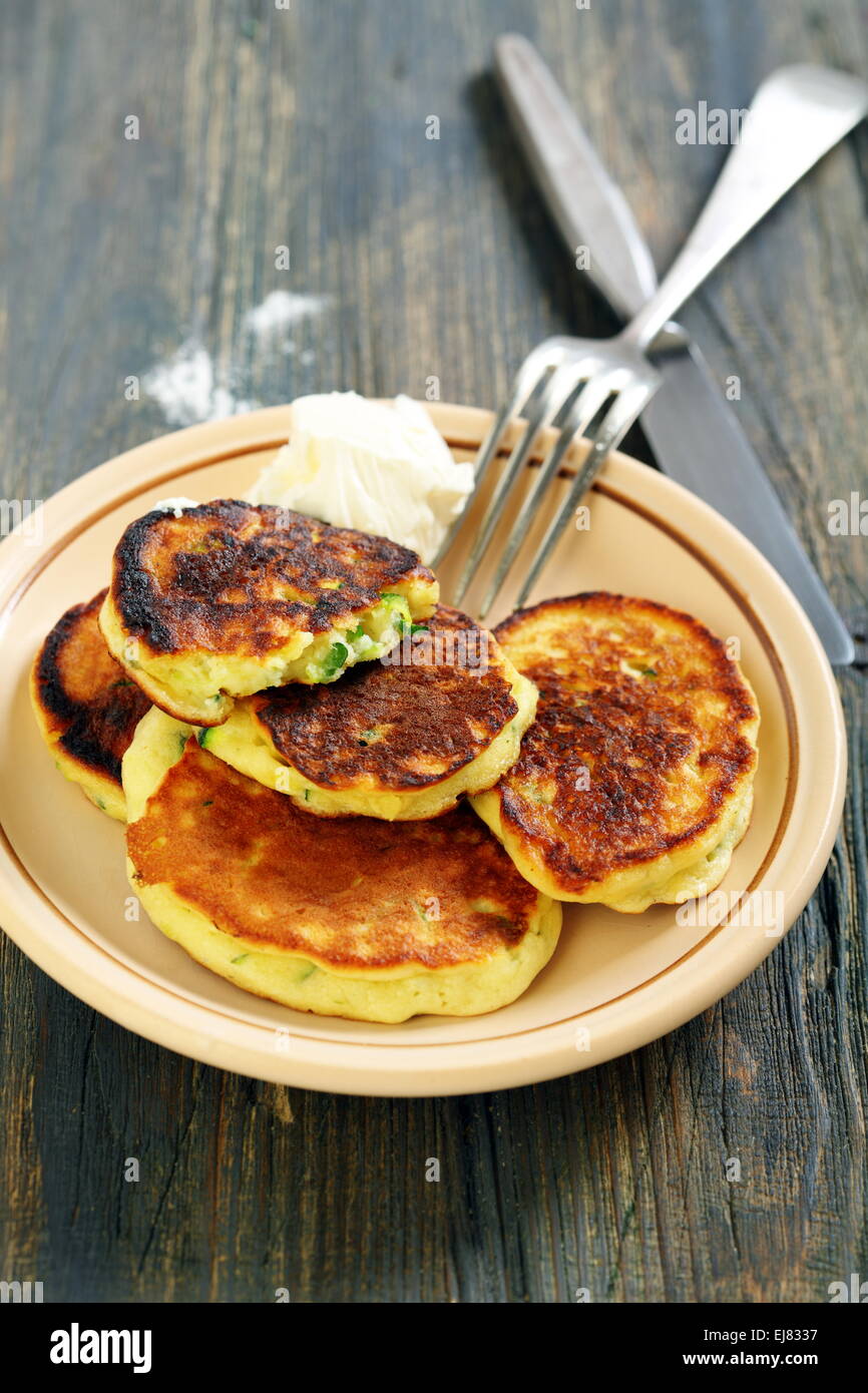 Pancakes on a plate, fork and knife. Stock Photo