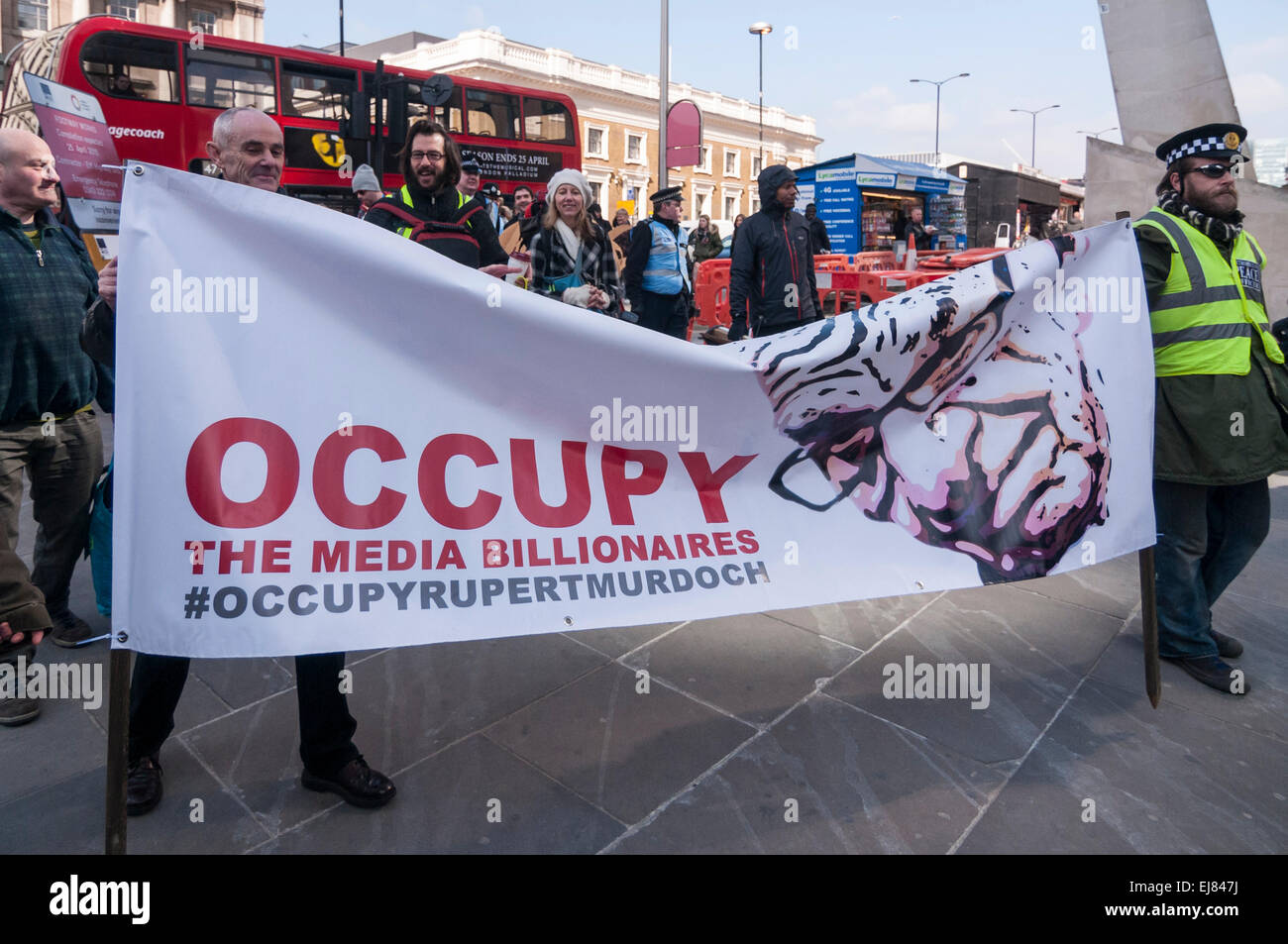London Bridge Station, London, UK.  23rd March, 2015. Demonstrators begin to arrange their placards outside News UK's headquarters, 'the Little Shard' near London Bridge as part of the Occupy Rupert Murdoch protest.  The protest is against the dominance of billionaire owners of UK media: Rupert Murdoch (News UK), Viscount Rothermere (Daily Mail Group), Richard Desmond (The Express) and the Barclay brothers (Telegraph). Credit:  Stephen Chung/Alamy Live News Stock Photo