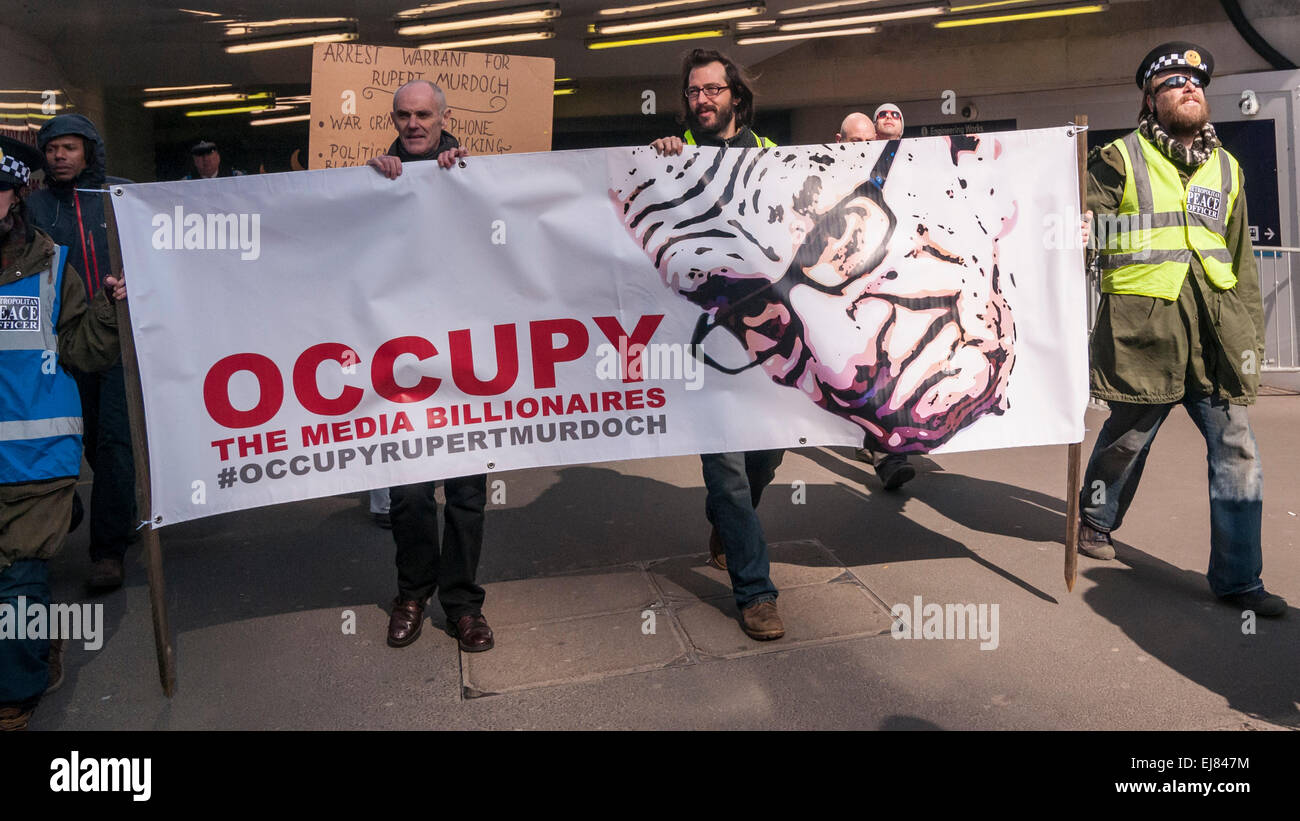 London Bridge Station, London, UK.  23rd March, 2015. Donnachadh McCarthy, Occupy spokesperson, third left, pictured with demonstrators gathering outside News UK's headquarters, 'the Little Shard' near London Bridge as part of the Occupy Rupert Murdoch protest.  The protest is against the dominance of billionaire owners of UK media: Rupert Murdoch (News UK), Viscount Rothermere (Daily Mail Group), Richard Desmond (The Express) and the Barclay brothers (Telegraph). Credit:  Stephen Chung/Alamy Live News Stock Photo