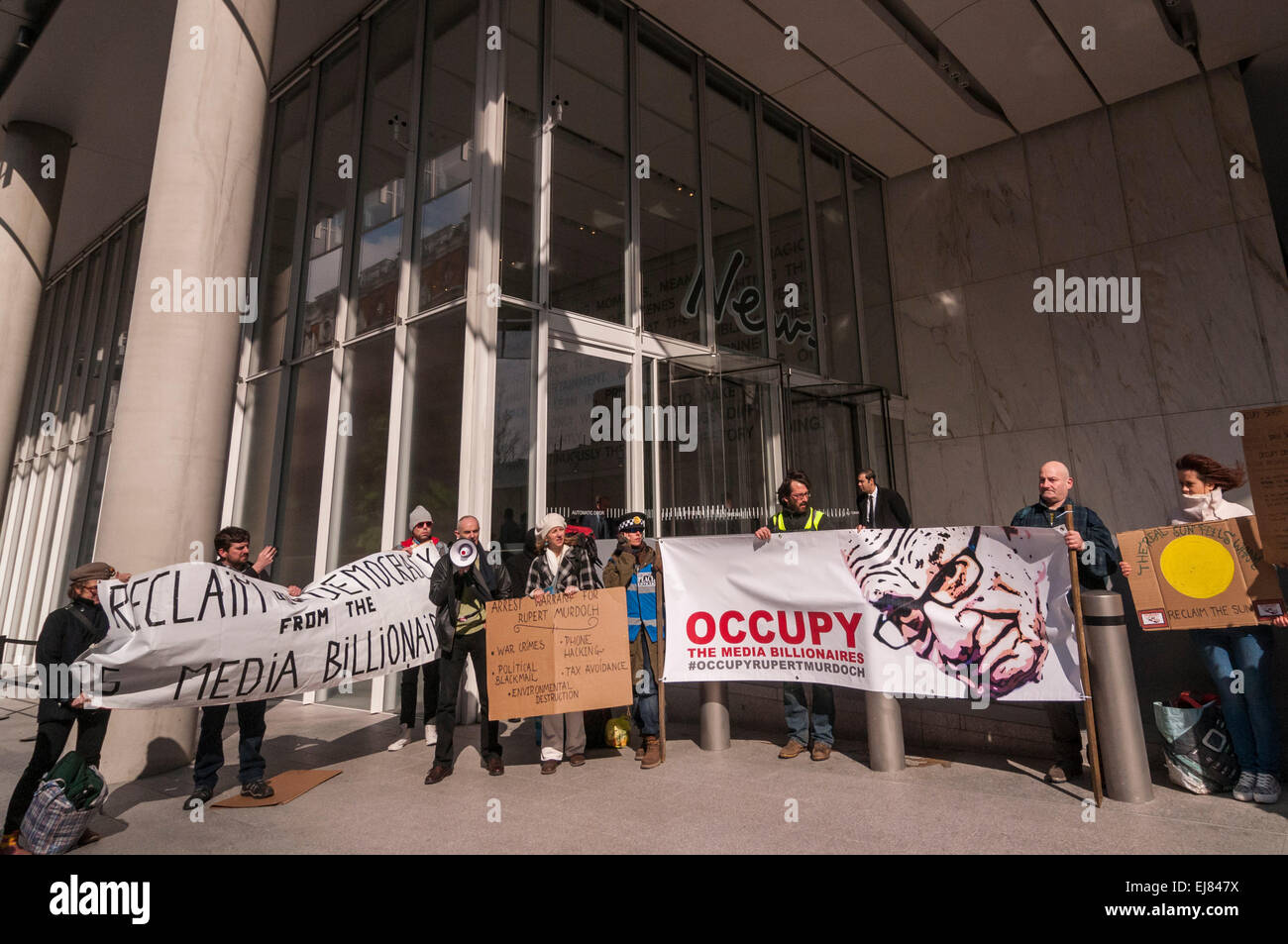 London Bridge Station, London, UK.  23rd March, 2015. Donnachadh McCarthy, Occupy spokesperson, pictured with demonstrators gathering outside News UK's headquarters, 'the Little Shard' near London Bridge as part of the Occupy Rupert Murdoch protest.  The protest is against the dominance of billionaire owners of UK media: Rupert Murdoch (News UK), Viscount Rothermere (Daily Mail Group), Richard Desmond (The Express) and the Barclay brothers (Telegraph). Credit:  Stephen Chung/Alamy Live News Stock Photo