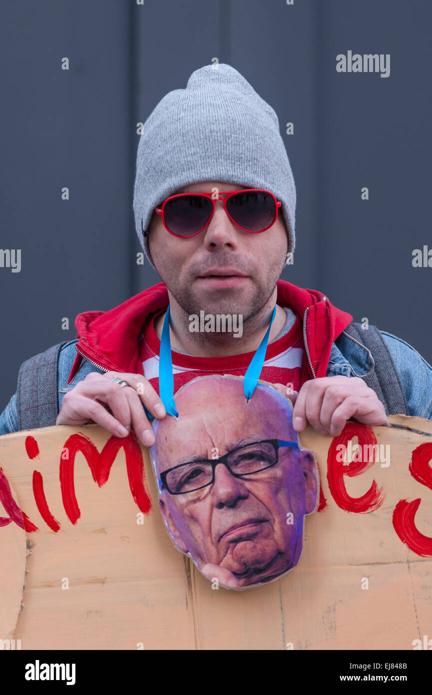 London Bridge Station, London, UK.  23rd March, 2015. A demonstrator with an image of Rupert Murdoch outside News UK's headquarters, 'the Little Shard' near London Bridge as part of the Occupy Rupert Murdoch protest.  The protest is against the dominance of billionaire owners of UK media: Rupert Murdoch (News UK), Viscount Rothermere (Daily Mail Group), Richard Desmond (The Express) and the Barclay brothers (Telegraph). Credit:  Stephen Chung/Alamy Live News Stock Photo